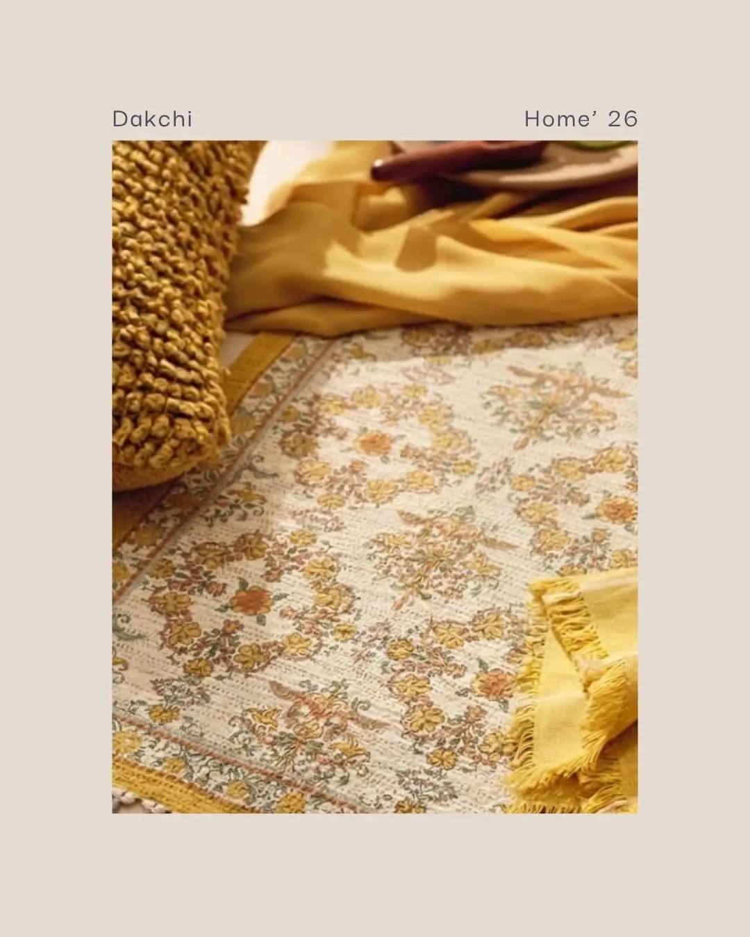 Close-up of a mustard and cream floral rug with a yellow fringed cushion